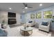 Inviting living room featuring a white brick fireplace, a ceiling fan, and two comfy chairs at 1302 Buffaloe Rd, Garner, NC 27529