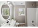 Bathroom with a single sink vanity, round mirror and a walk-in shower at 131 Cricketgrass Dr, Cary, NC 27513