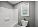Bathroom featuring a white shower and tub combination, toilet, and a window with natural light at 131 Cricketgrass Dr, Cary, NC 27513