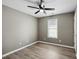 An empty bedroom featuring new floors, a window with natural light, and neutral colored walls at 131 Cricketgrass Dr, Cary, NC 27513
