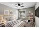 Well-lit bedroom features a comfortable bed, stylish decor, and a window view at 131 Cricketgrass Dr, Cary, NC 27513