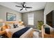 This cozy bedroom features a ceiling fan and a comfortable bed with stylish decor at 131 Cricketgrass Dr, Cary, NC 27513