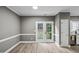 Bright dining area features French doors to the backyard and neutral tones at 131 Cricketgrass Dr, Cary, NC 27513
