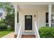 Inviting front porch with black front door and charming architectural details at 131 Cricketgrass Dr, Cary, NC 27513