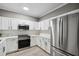 Bright kitchen with stainless steel appliances, white cabinets, and light countertops for a modern, clean look at 131 Cricketgrass Dr, Cary, NC 27513