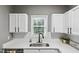 Close-up of the kitchen sink area, highlighting the modern faucet and white countertops at 131 Cricketgrass Dr, Cary, NC 27513