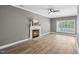 Bright living room with a fireplace, hardwood floors, and a ceiling fan at 131 Cricketgrass Dr, Cary, NC 27513