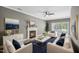 Elegant living room with a cozy fireplace, plush seating, and stylish decor at 131 Cricketgrass Dr, Cary, NC 27513