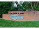 A decorative sign on a brick wall for Hermitage Park with flowers along the top at 131 Cricketgrass Dr, Cary, NC 27513