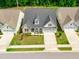 Stunning aerial view of a home with landscaped front yard, paved driveway, and stone-accented facade at 131 English Violet Ln, Raleigh, NC 27610