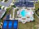 This aerial view showcases a community pool, tennis courts, and bocce ball court, all near a stylish clubhouse at 131 English Violet Ln, Raleigh, NC 27610