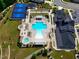 This aerial shot features a clubhouse with a pool, tennis court, and bocce ball, offering recreational amenities for residents at 131 English Violet Ln, Raleigh, NC 27610