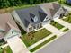 An aerial view shows new homes with manicured lawns and driveways, showcasing the neighborhood's curb appeal at 131 English Violet Ln, Raleigh, NC 27610