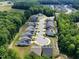 This aerial view showcases a neighborhood with well-maintained houses, winding streets, and lush greenery with ponds at 131 English Violet Ln, Raleigh, NC 27610