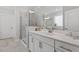 Modern bathroom with a glass-enclosed shower, dual vanity, and neutral color scheme at 131 English Violet Ln, Raleigh, NC 27610