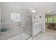 Bright bathroom featuring a glass enclosed shower, white vanity, and neutral tiling at 131 English Violet Ln, Raleigh, NC 27610