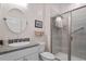 Bathroom features a granite countertop vanity and glass shower with stylish tile at 131 English Violet Ln, Raleigh, NC 27610