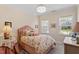 Cozy bedroom with two windows, floral bedding, and neutral walls at 131 English Violet Ln, Raleigh, NC 27610