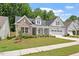 Charming home featuring a stone facade, well-manicured lawn, and a convenient two-car garage at 131 English Violet Ln, Raleigh, NC 27610