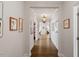 Elegant hallway with hardwood floors, decorative lighting, and framed artwork at 131 English Violet Ln, Raleigh, NC 27610