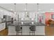 Gourmet kitchen with stainless steel appliances, ample counter space, and bar seating at 131 English Violet Ln, Raleigh, NC 27610