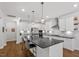 Spacious open kitchen with island, pendant lights, and stainless steel appliances at 131 English Violet Ln, Raleigh, NC 27610