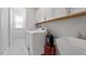 Bright laundry room with white cabinets and modern appliances at 131 English Violet Ln, Raleigh, NC 27610