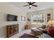 Comfortable living room with a ceiling fan, area rug, and large windows at 131 English Violet Ln, Raleigh, NC 27610