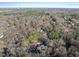 Suburban house aerial view, featuring tree-lined streets, mature trees, and lush greenery at 1401 Granada Dr, Raleigh, NC 27612