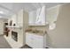 Basement bar area with countertop, cabinetry, and fireplace at 1401 Granada Dr, Raleigh, NC 27612