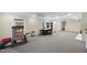 Open basement area with carpet, natural light, and recreational spaces at 1401 Granada Dr, Raleigh, NC 27612