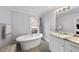 Bright bathroom features soaking tub, vanity with marble countertop, and tile flooring at 1401 Granada Dr, Raleigh, NC 27612