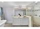 Elegant bathroom featuring double vanity, marble countertops, and tiled walk-in shower at 1401 Granada Dr, Raleigh, NC 27612