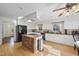 Spacious kitchen features a brick island with cooktop, granite countertops, stainless steel appliances, and ample cabinet space at 1401 Granada Dr, Raleigh, NC 27612