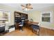 Dedicated home office with hardwood floors, built-in shelving, and ample natural light, great for productivity at 1401 Granada Dr, Raleigh, NC 27612