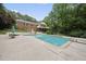 Beautiful backyard featuring an in-ground pool, patio, and lush landscaping at 1401 Granada Dr, Raleigh, NC 27612