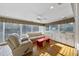 Bright sunroom with large windows, hardwood floors, and built-in cabinets, perfect for relaxation and entertaining at 1401 Granada Dr, Raleigh, NC 27612