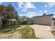 Fenced backyard featuring a detached garage and a concrete parking area at 148 Danesway Dr, Holly Springs, NC 27540