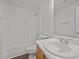 Well-lit bathroom featuring a shower-tub combination and a stylish vanity with storage at 148 Danesway Dr, Holly Springs, NC 27540