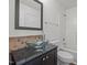 Bathroom features glass bowl sink, decorative tile backsplash, and shower over tub at 148 Danesway Dr, Holly Springs, NC 27540