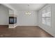 Dining room features a tiled fireplace, neutral walls, wood floor, and a modern chandelier at 148 Danesway Dr, Holly Springs, NC 27540