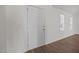 Bright entryway featuring a white door, wood flooring, and natural light from a nearby window at 148 Danesway Dr, Holly Springs, NC 27540