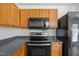 Updated kitchen features stainless steel appliances, wood cabinets and a microwave at 148 Danesway Dr, Holly Springs, NC 27540
