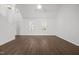 Open concept living room with wood flooring, lots of windows, and plenty of space at 148 Danesway Dr, Holly Springs, NC 27540