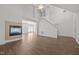 Bright and open living space with fireplace, staircase, and sliding glass door for backyard access at 148 Danesway Dr, Holly Springs, NC 27540