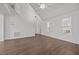 Open living area with high ceilings, wood floors, stairway, and multiple windows for natural light at 148 Danesway Dr, Holly Springs, NC 27540