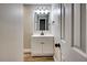 Bathroom vanity with cabinets, a white countertop, a sink, a mirror, and modern lighting at 1592 Boone Rd, Elon, NC 27244