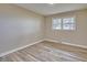 Cozy bedroom with ample natural light and stylish wood-look floors at 1592 Boone Rd, Elon, NC 27244