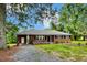 Inviting brick home with a spacious front yard, featuring a covered entrance and classic design elements at 1592 Boone Rd, Elon, NC 27244