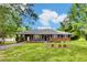 Charming brick home with a covered carport and well-maintained front yard, exuding curb appeal at 1592 Boone Rd, Elon, NC 27244